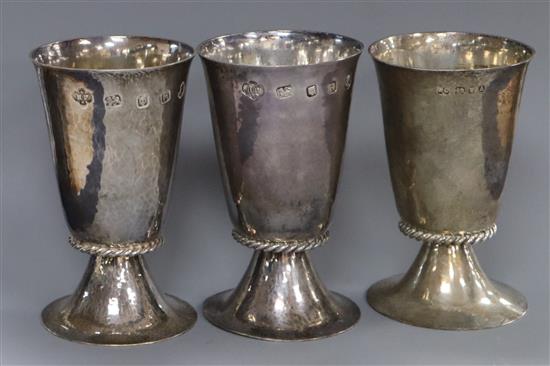 A pair of QE II hammered silver goblets, H. Phillips, London, 1952 and one other silver goblet, 11 oz.